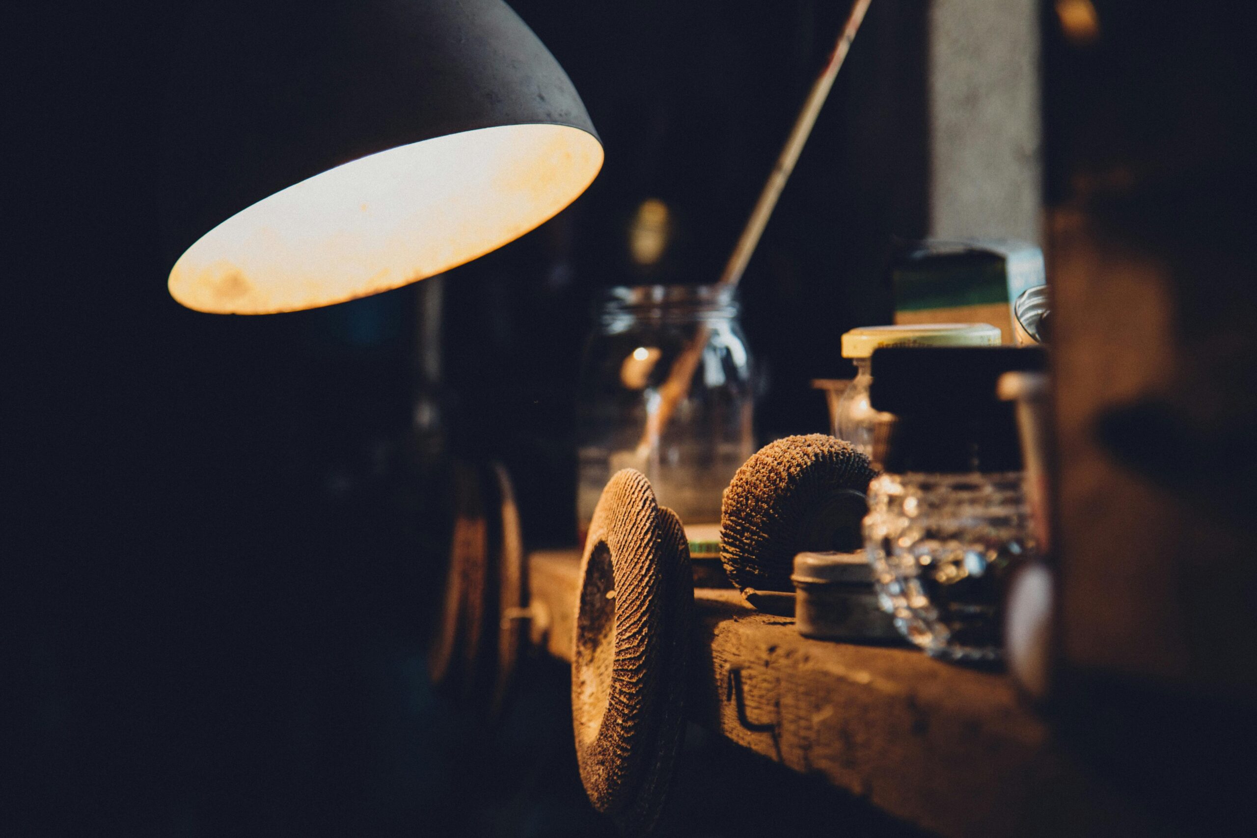 Explore a cozy, vintage workshop illuminated by warm lighting, showcasing tools and equipment.